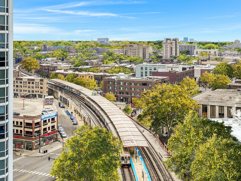 an aerial view of a city with train tracks