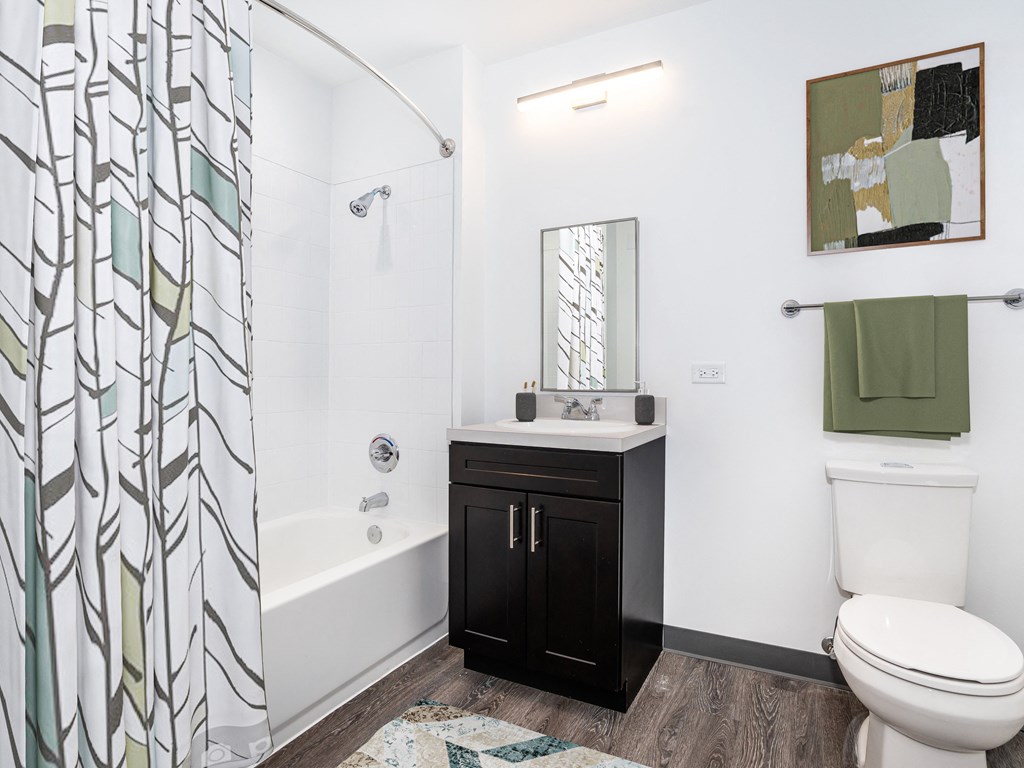 a bathroom with a shower and a toilet and a sink