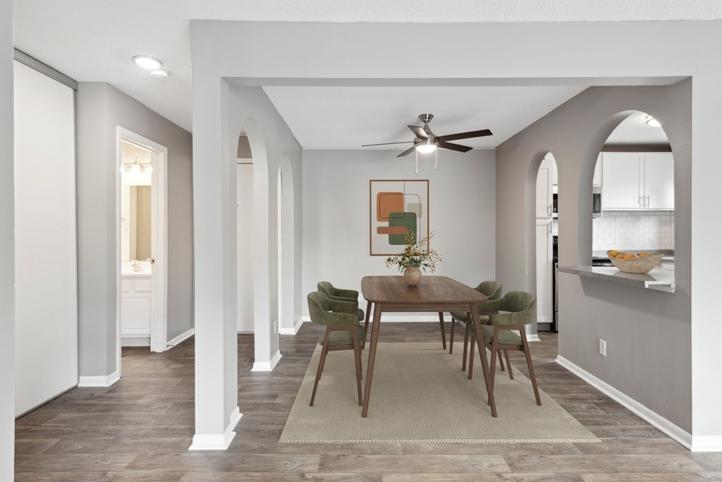 A dining room with a table set for four.