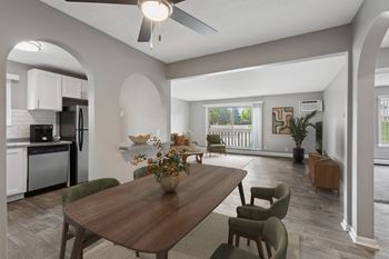 A dining room with a wooden table and chairs.