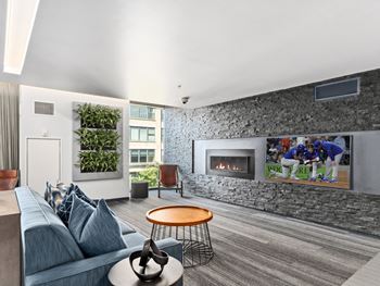 a living room with a fireplace and a tv on the wall at One 333, Chicago, IL