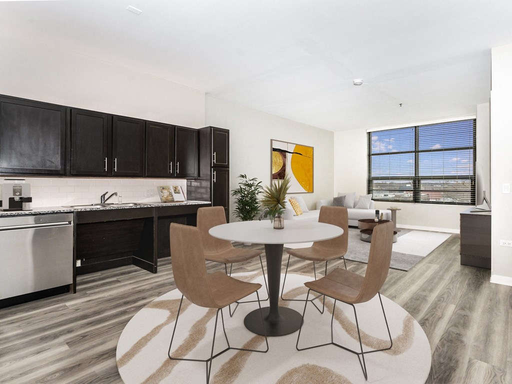 a living room and kitchen with a table and chairs