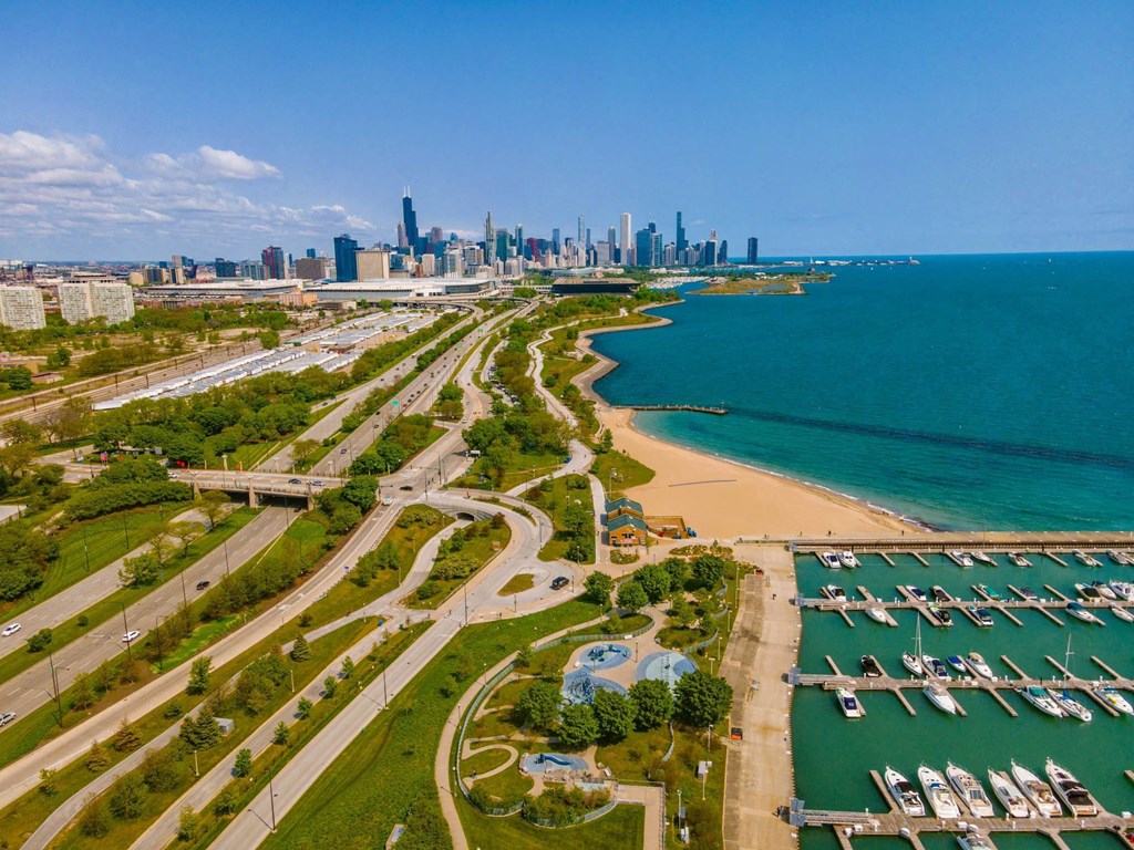 A cityscape with a beach and a marina.