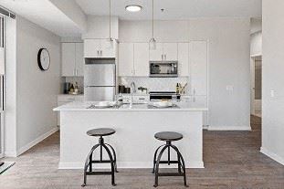 a kitchen with a counter and two stools