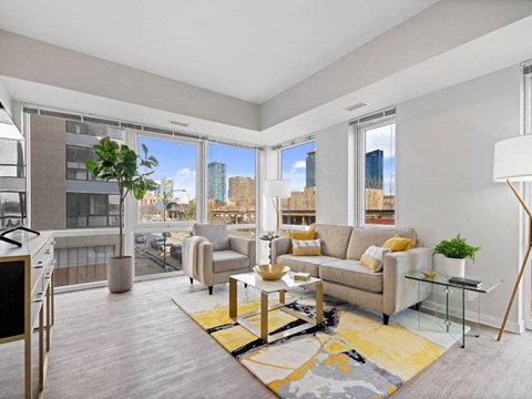 A living room with a couch, chairs, and a coffee table.