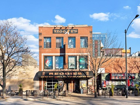 A building with a sign that says "REGGIE'S" on it.