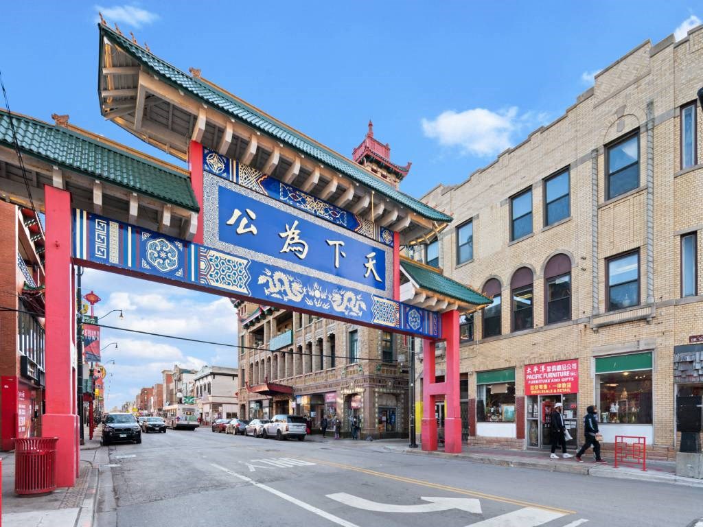 A street view with a red and blue archway in the middle.