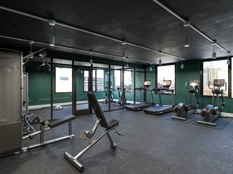 A gym with a variety of equipment including a rowing machine.