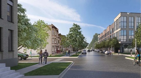 A street view with cars, bicycles and pedestrians.
