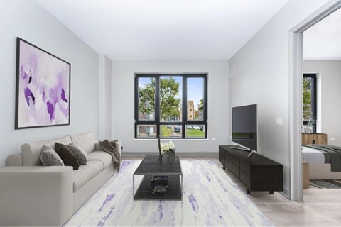 A modern living room with a large painting on the wall and a view of the outside through the windows.