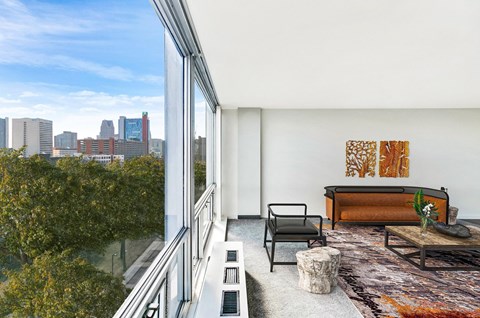 A modern living room with a view of the city skyline.