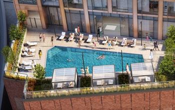 an aerial view of a swimming pool in front of a building at Cassidy on Canal, Chicago, IL