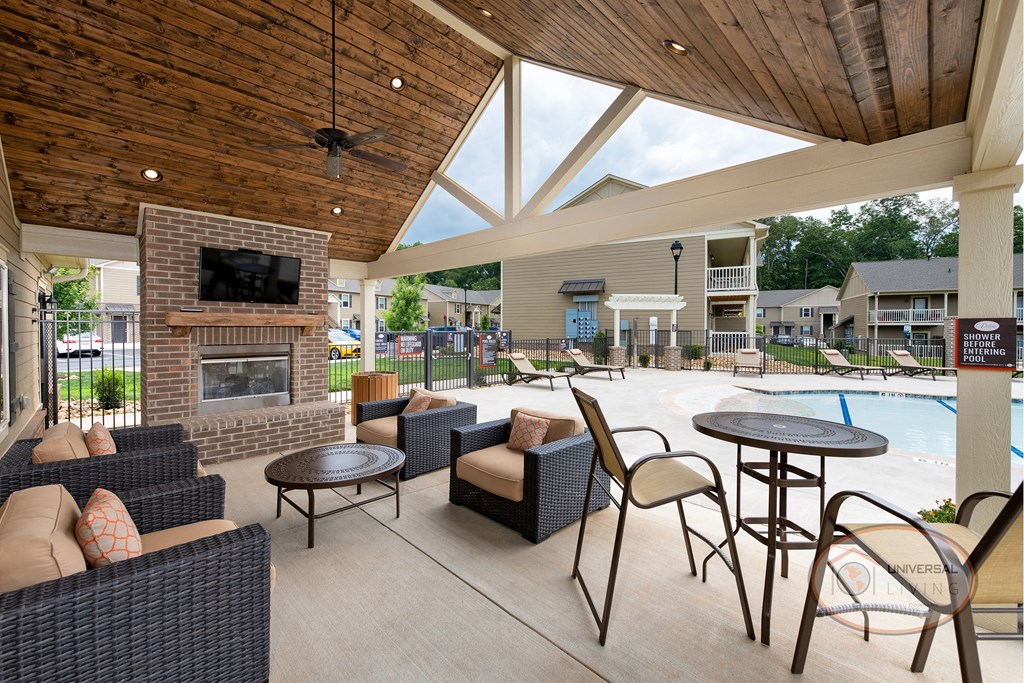 the preserve at ballantyne commons clubhouse with tables and chairs and a pool