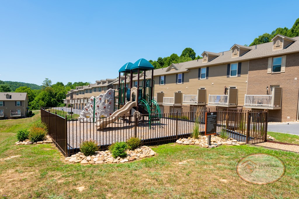 A soft topped playground with seating.