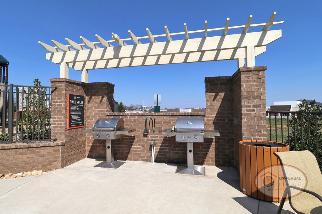 a barbecue area with two bbq grills and a white roof