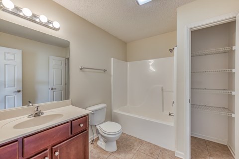 A bathroom with a sink, toilet, and bathtub.