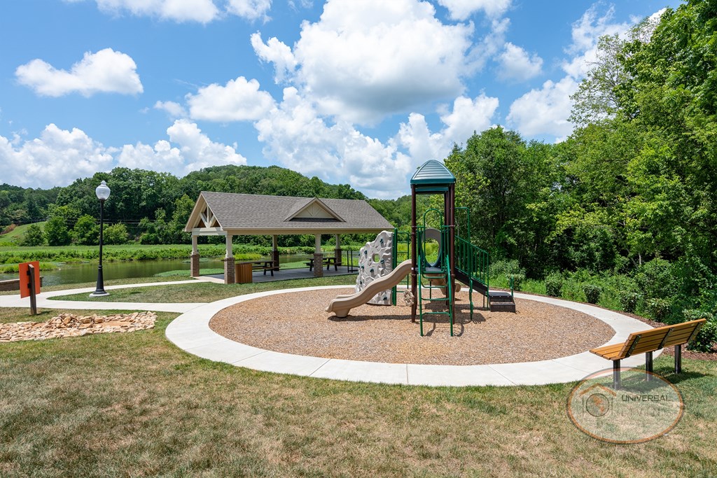A soft-topped playground with seating.