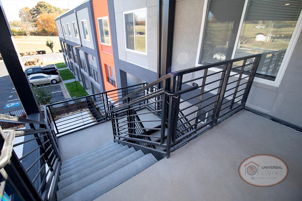 a spiral staircase leading up to a balcony in a building