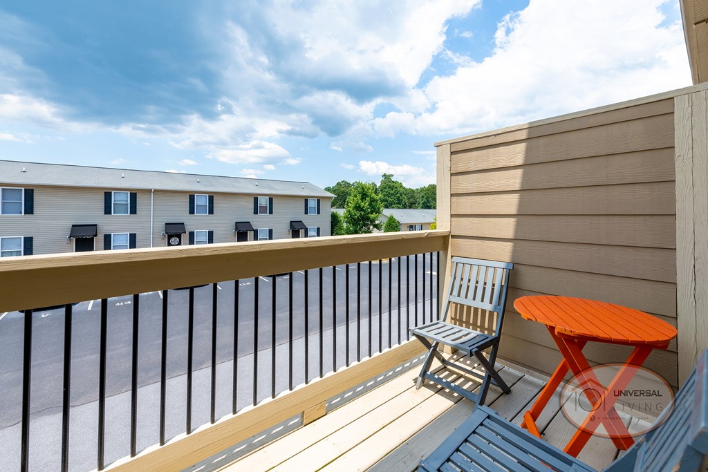 A balcony with a chair and a table.