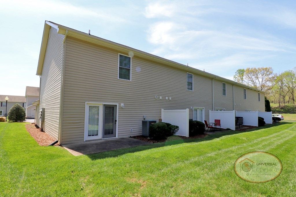 a white house with a yard in front of it