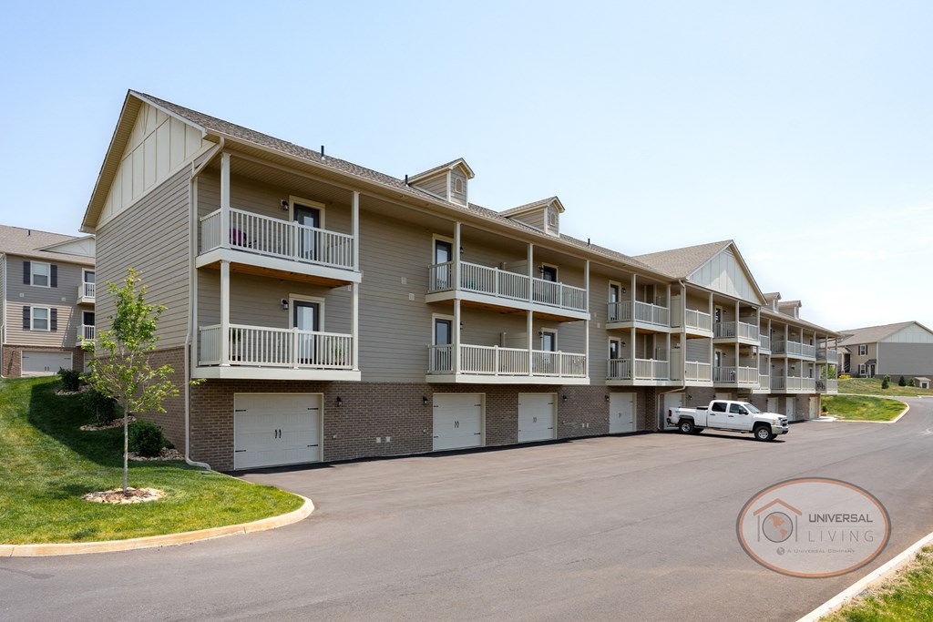 a street view of an apartment building with a car parked in front