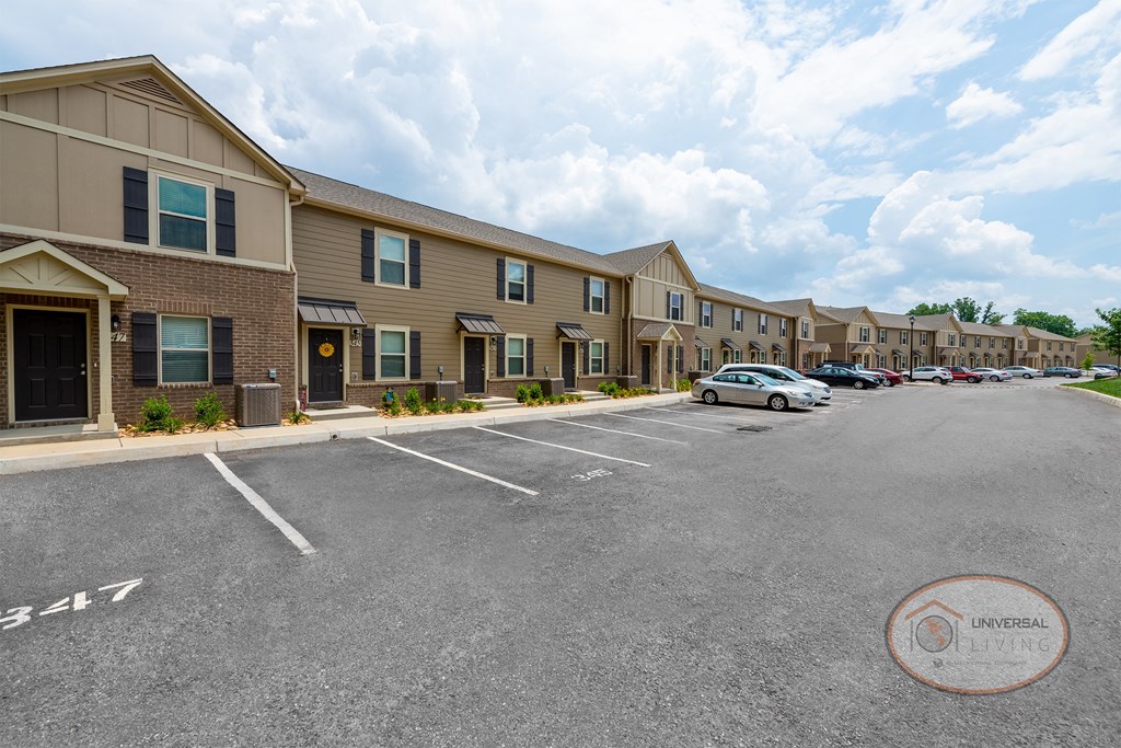 an empty parking lot in front of an apartment building