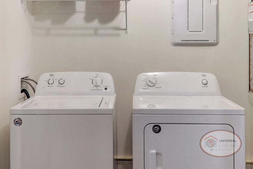 A laundry room with a washer and a dryer.