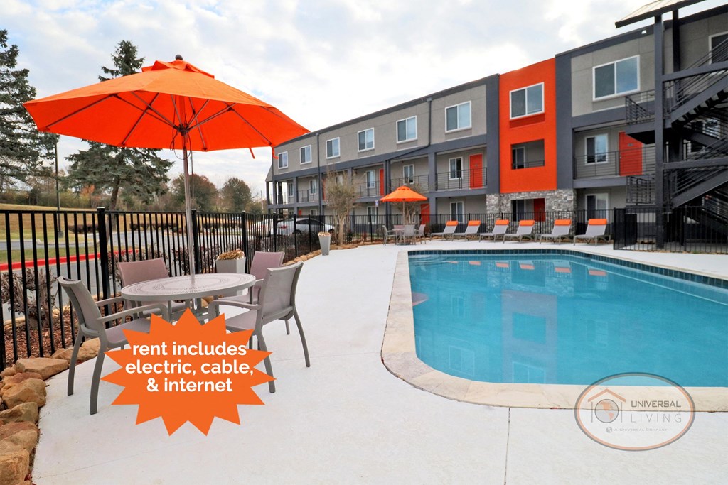 our apartments have a large pool and patio with umbrellas