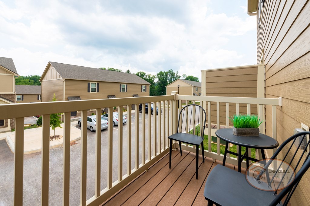 a balcony with two chairs and a table on it