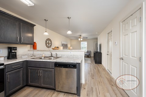 A kitchen with dark wood cabinets and a white countertop.