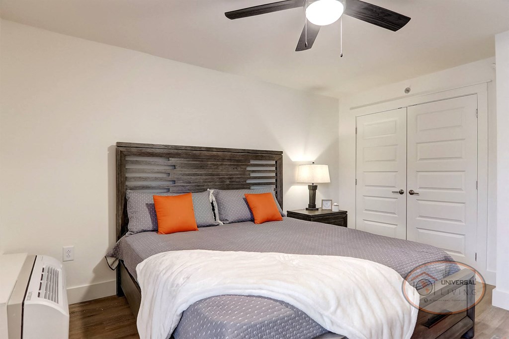 a bedroom with a bed and a ceiling fan