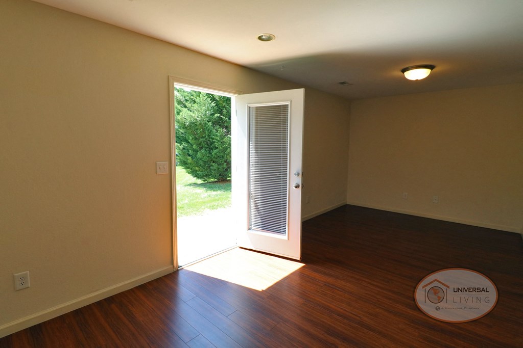 The living room with a door to the patio.