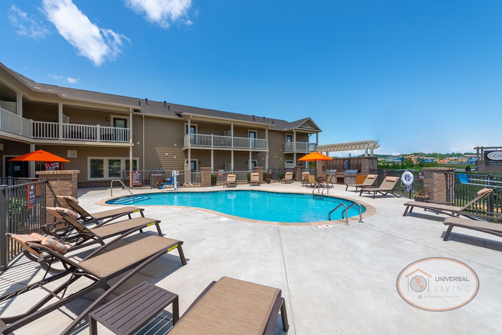 Villas at Pigeon River Swimming pool with lounge chairs surrounded by apartments.