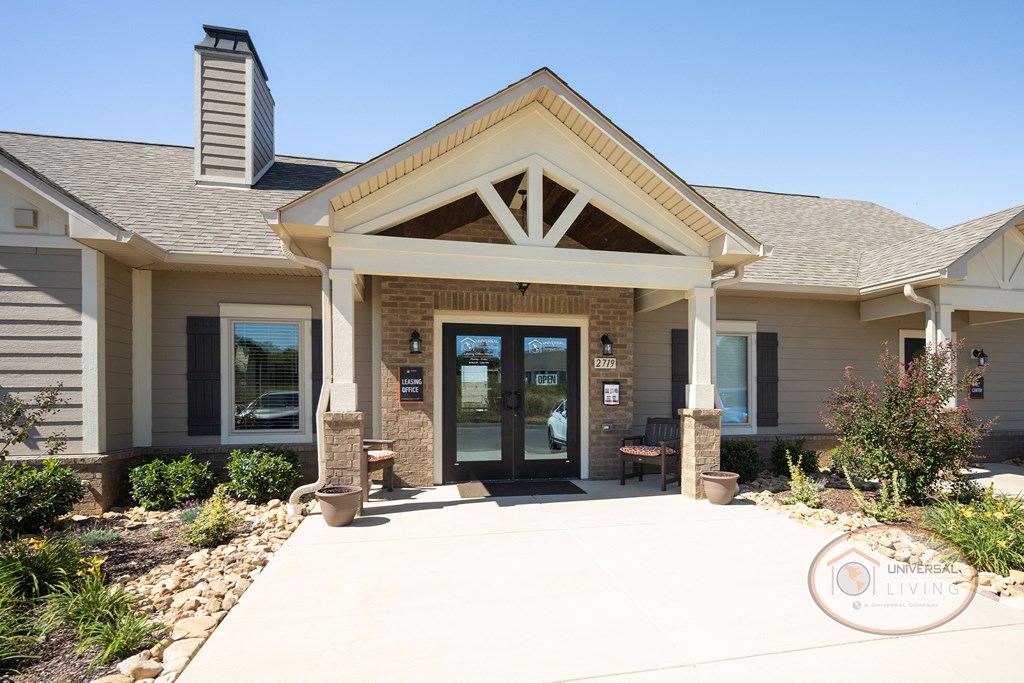 The clubhouse and leasing office with tan siding.