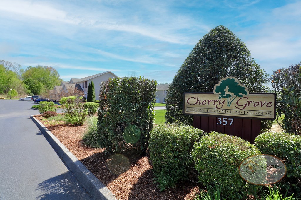 The entrance sign into the community reads "Cherry Grove Condominiums."