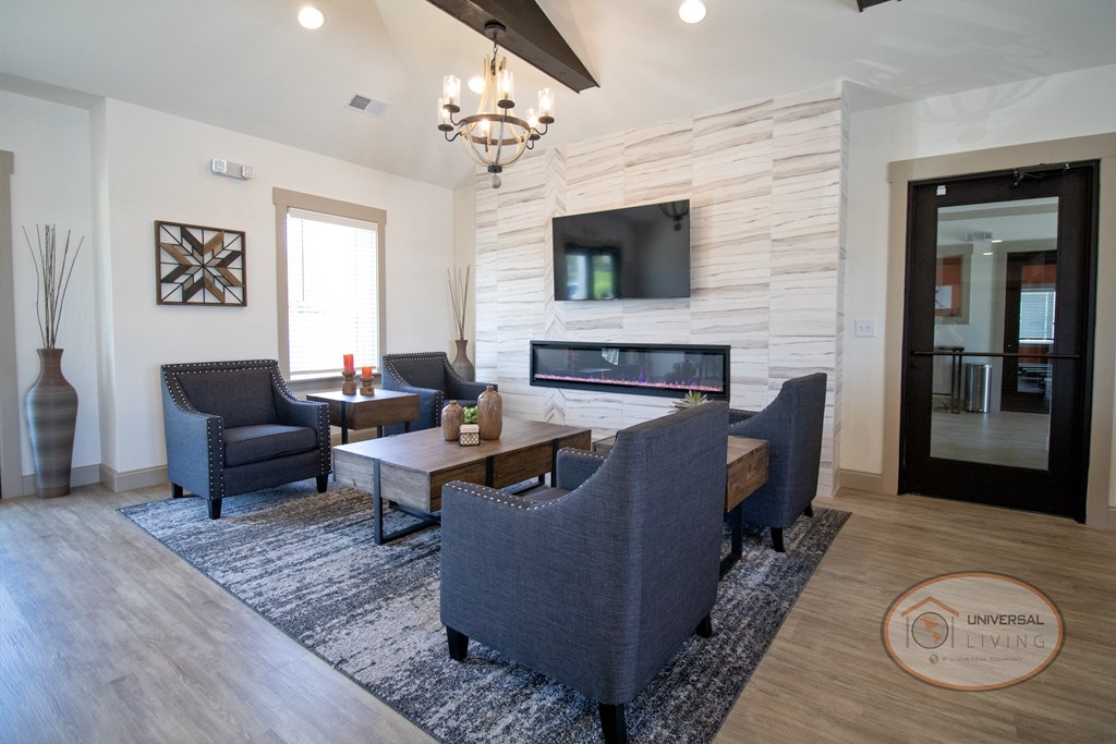 The clubhouse lounge with fireplace, flat screen TV, and lounge chairs.