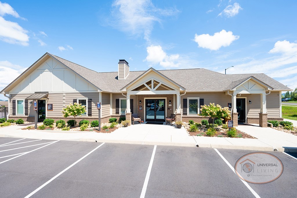 the exterior of a building with a parking lot and a driveway