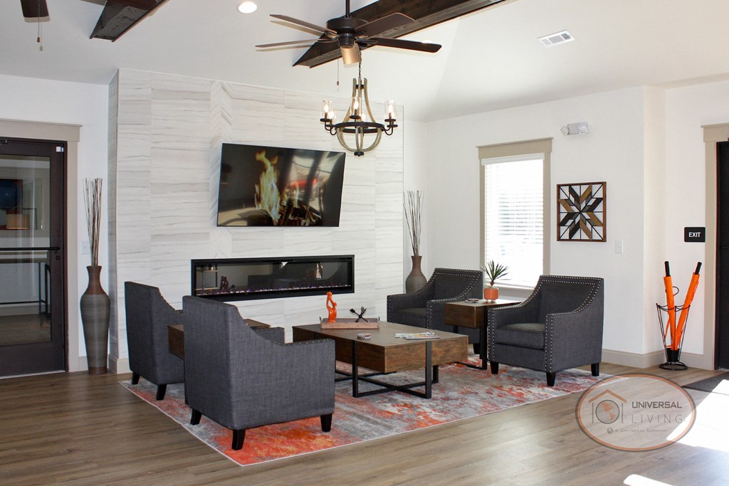 Clubhouse Lounge with fireplace, flat-screen TV, coffee bar, and lounge area.