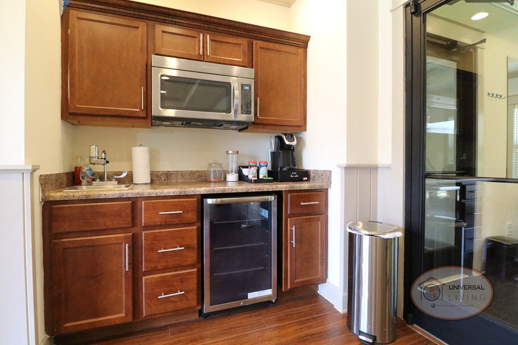 A coffee bar with a microwave and mini fridge.