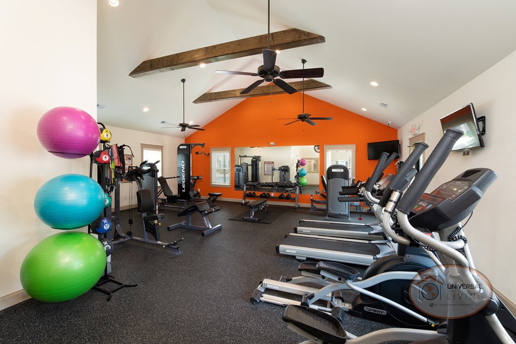 gym with cardio equipment and exercise balls at the oxford condos tx