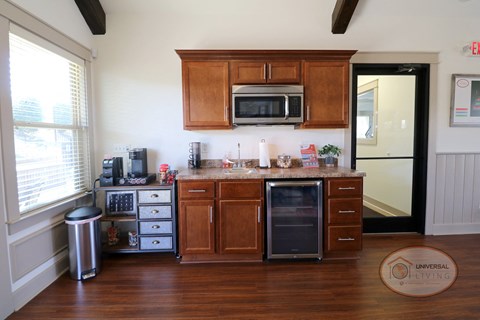 a kitchen with wooden cabinets and a sink and a refrigerator