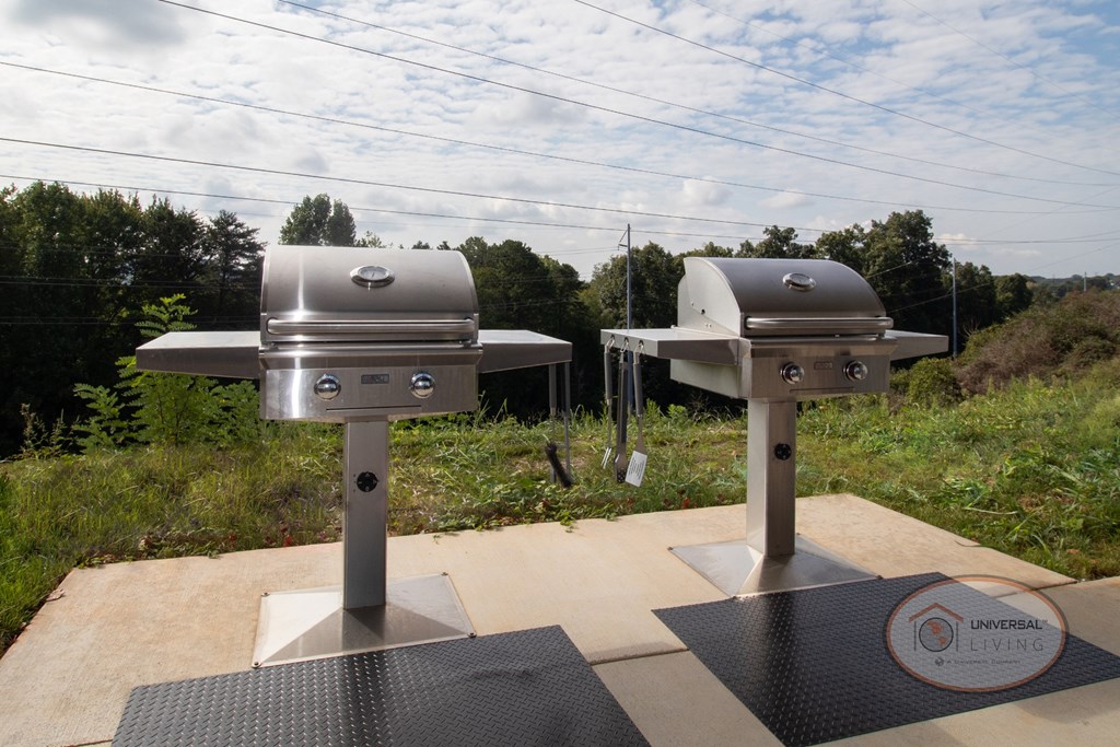 Two stainless steel grills under the pavilion.