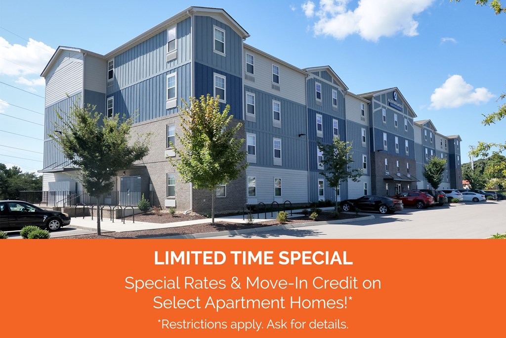 Apartment complex with a sign offering special rates and move-in credit.
