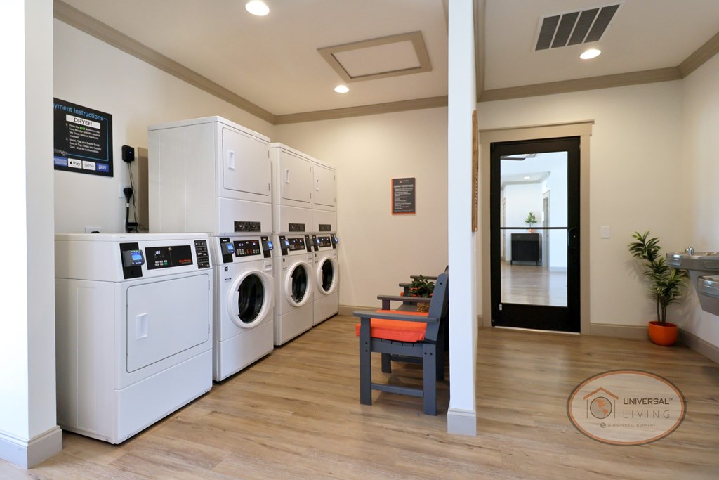 The resident laundry center with washing machines, dryers, and seating.