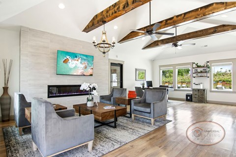 A living room with a grey couch, a wooden coffee table, and a painting on the wall.