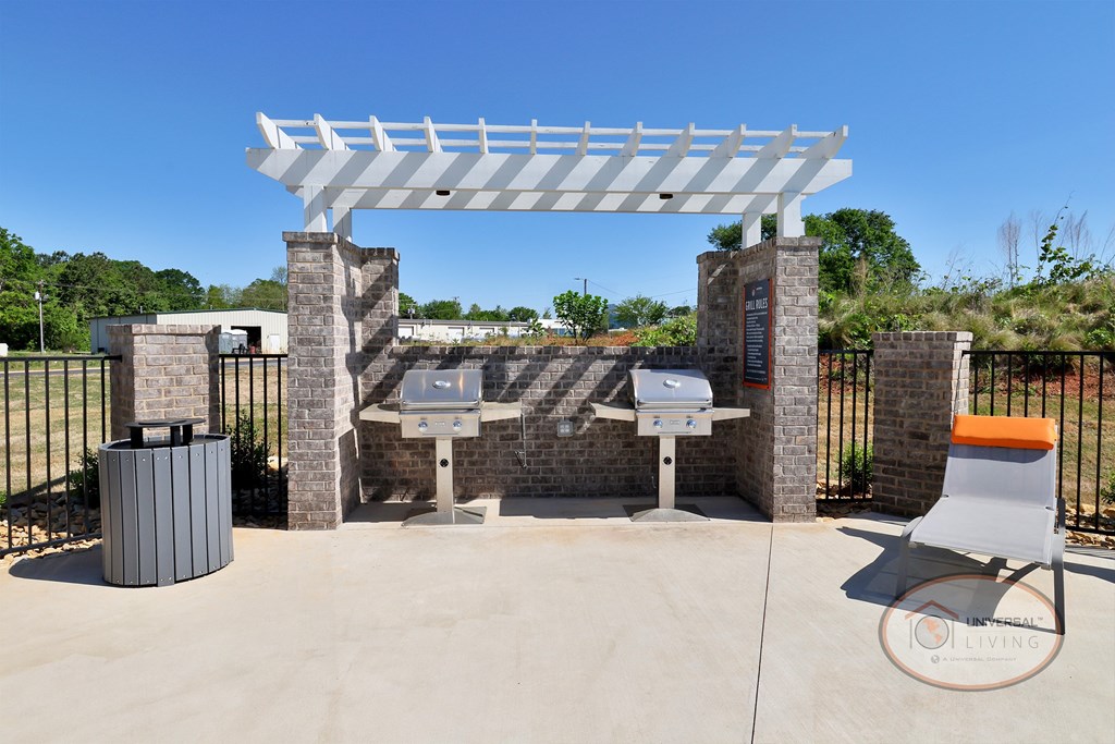 Two stainless steel grills on the patio by the pool.