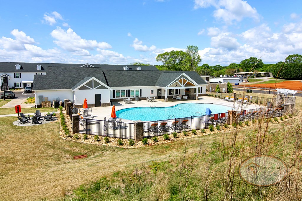 A sweeping view of the apartment community's clubhouse, zero entry pool and other amenities.