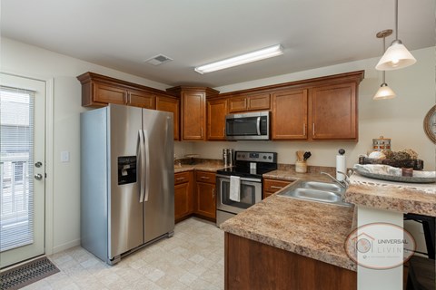 a kitchen with stainless steel appliances and granite counter tops