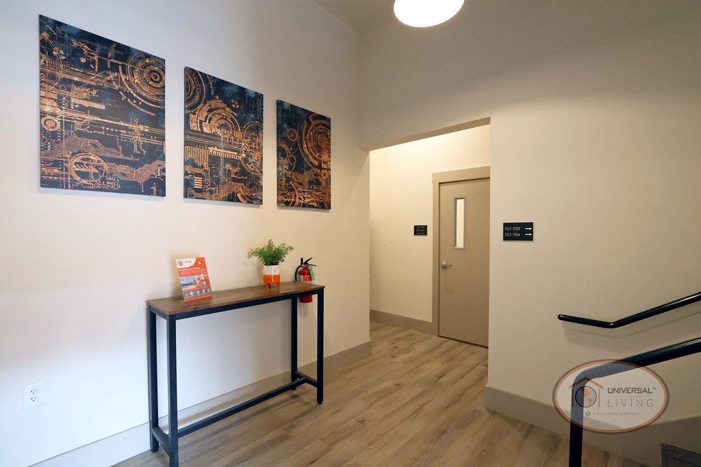 An entryway wat The Henry on Main with a table, mailboxes, and staircase.