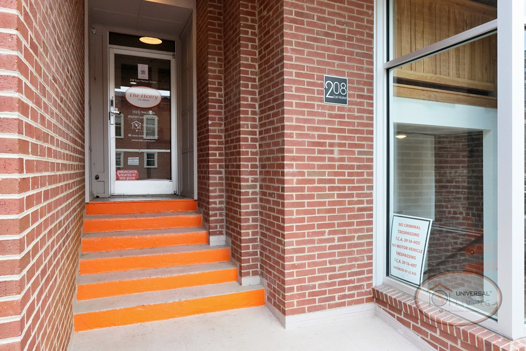 A close up of an entrance way to The Henry on Main with orange steps.